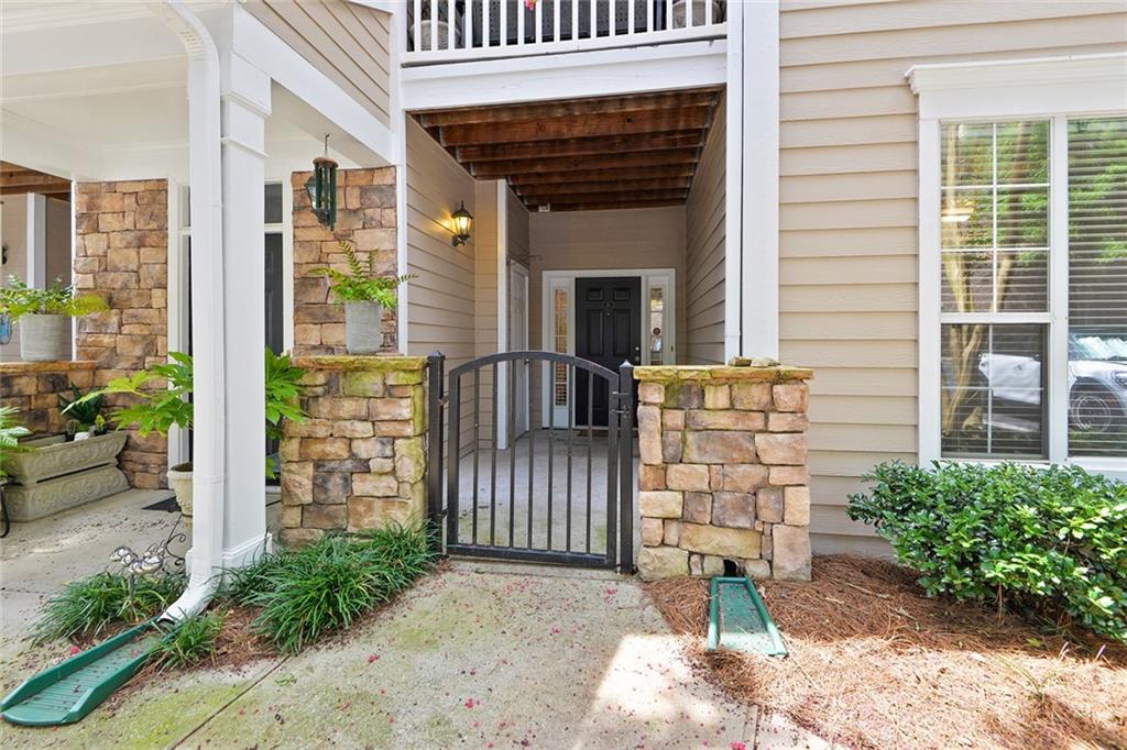 2400 Cumberland Parkway Southeast, Unit 611 Atlanta, GA 30339 - Photo 26 of 26 a view of a porch with a table and chair and potted plants