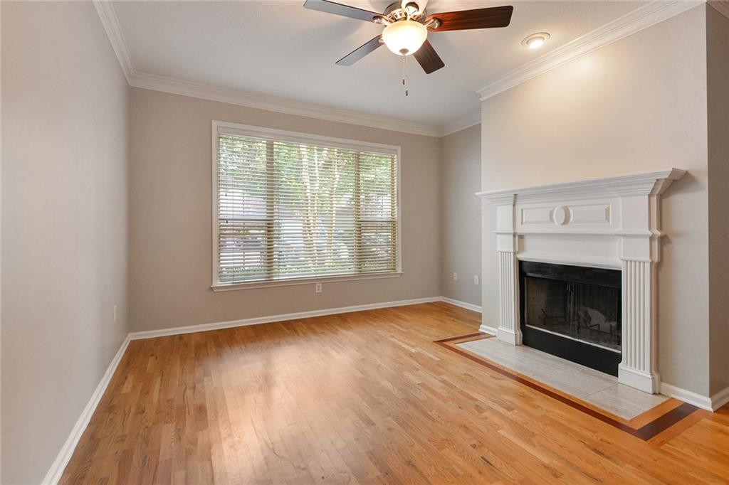 2400 Cumberland Parkway Southeast, Unit 611 Atlanta, GA 30339 - Photo 5 of 26 a view of an empty room with wooden floor fireplace and a window