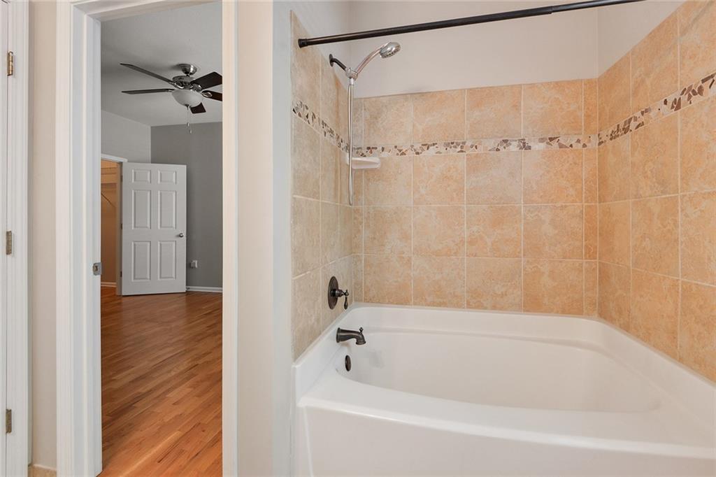 2400 Cumberland Parkway Southeast, Unit 611 Atlanta, GA 30339 - Photo 6 of 26 a bathroom with a shower and a bath tub