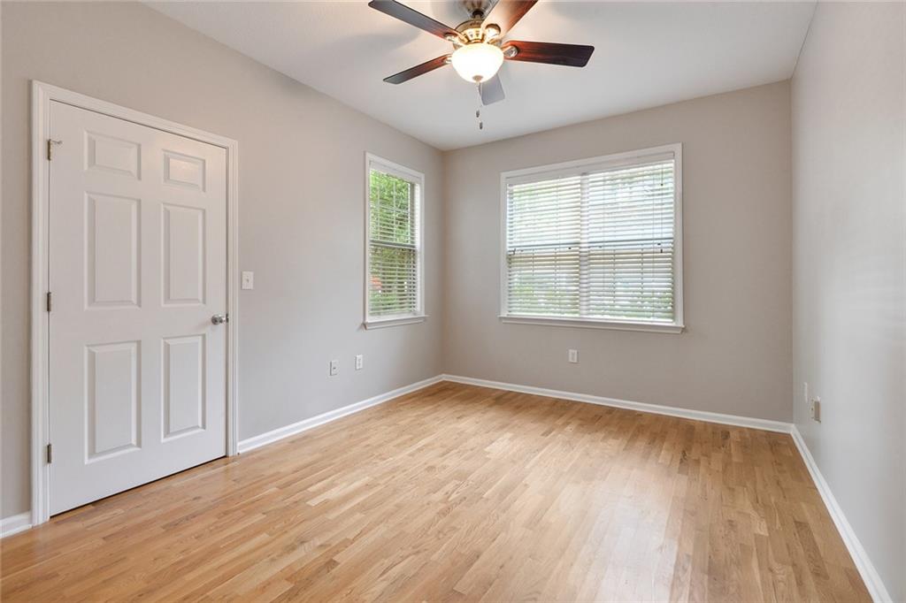 2400 Cumberland Parkway Southeast, Unit 611 Atlanta, GA 30339 - Photo 9 of 26 a view of an empty room with wooden floor and a window