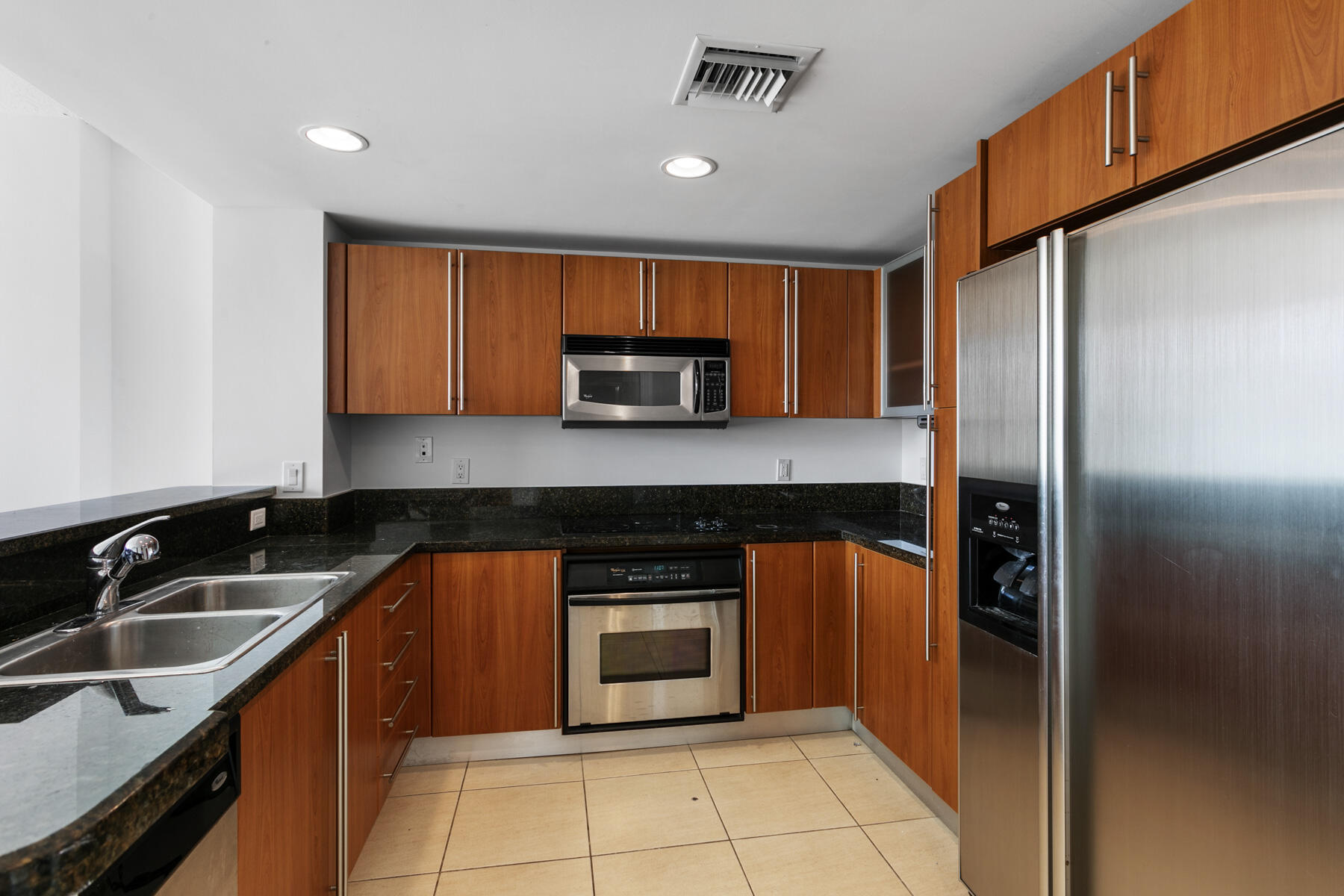 610 Clematis Street, Unit 736 West Palm Beach, FL 33401 - Photo 21 of 37 a kitchen with stainless steel appliances granite countertop a refrigerator and a sink
