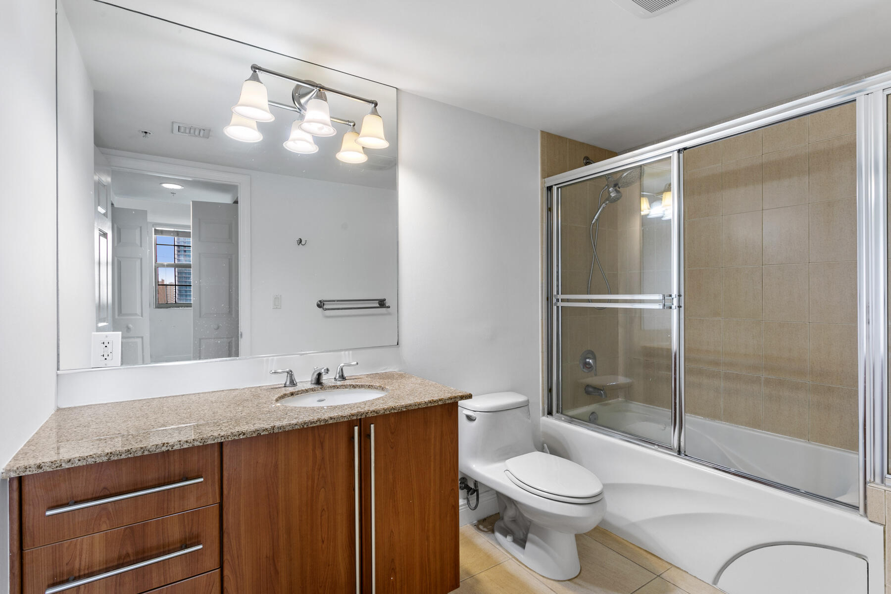 610 Clematis Street, Unit 736 West Palm Beach, FL 33401 - Photo 31 of 37 a bathroom with a granite countertop sink toilet and shower