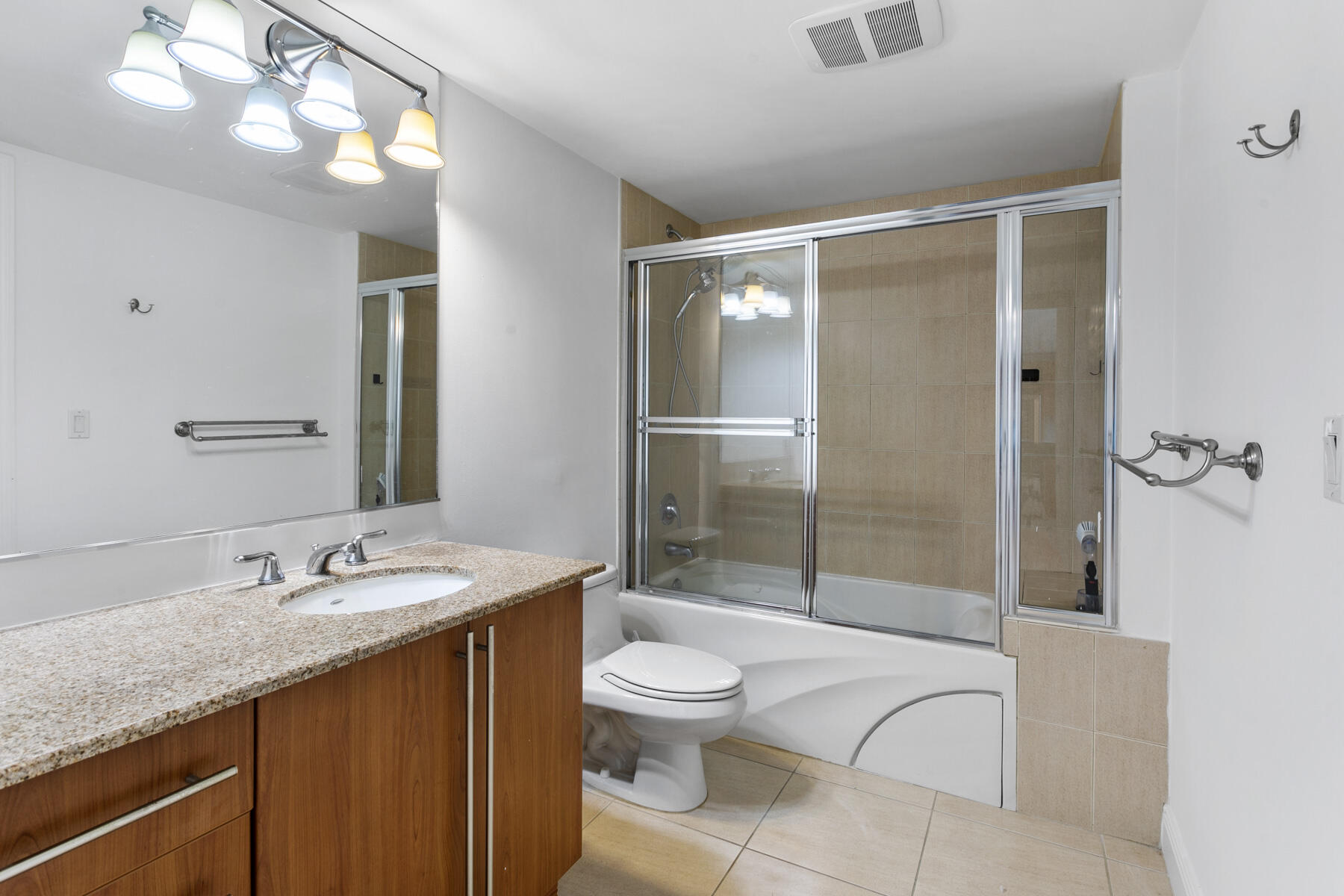 610 Clematis Street, Unit 736 West Palm Beach, FL 33401 - Photo 32 of 37 a bathroom with a granite countertop sink toilet and shower