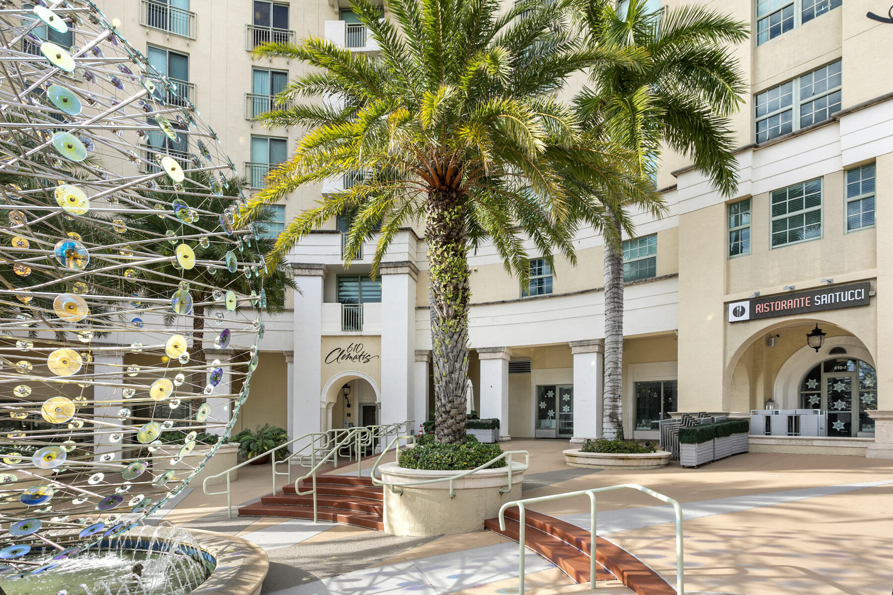 610 Clematis Street, Unit 736 West Palm Beach, FL 33401 - Photo 37 of 37 a front view of a building with garden and entryway