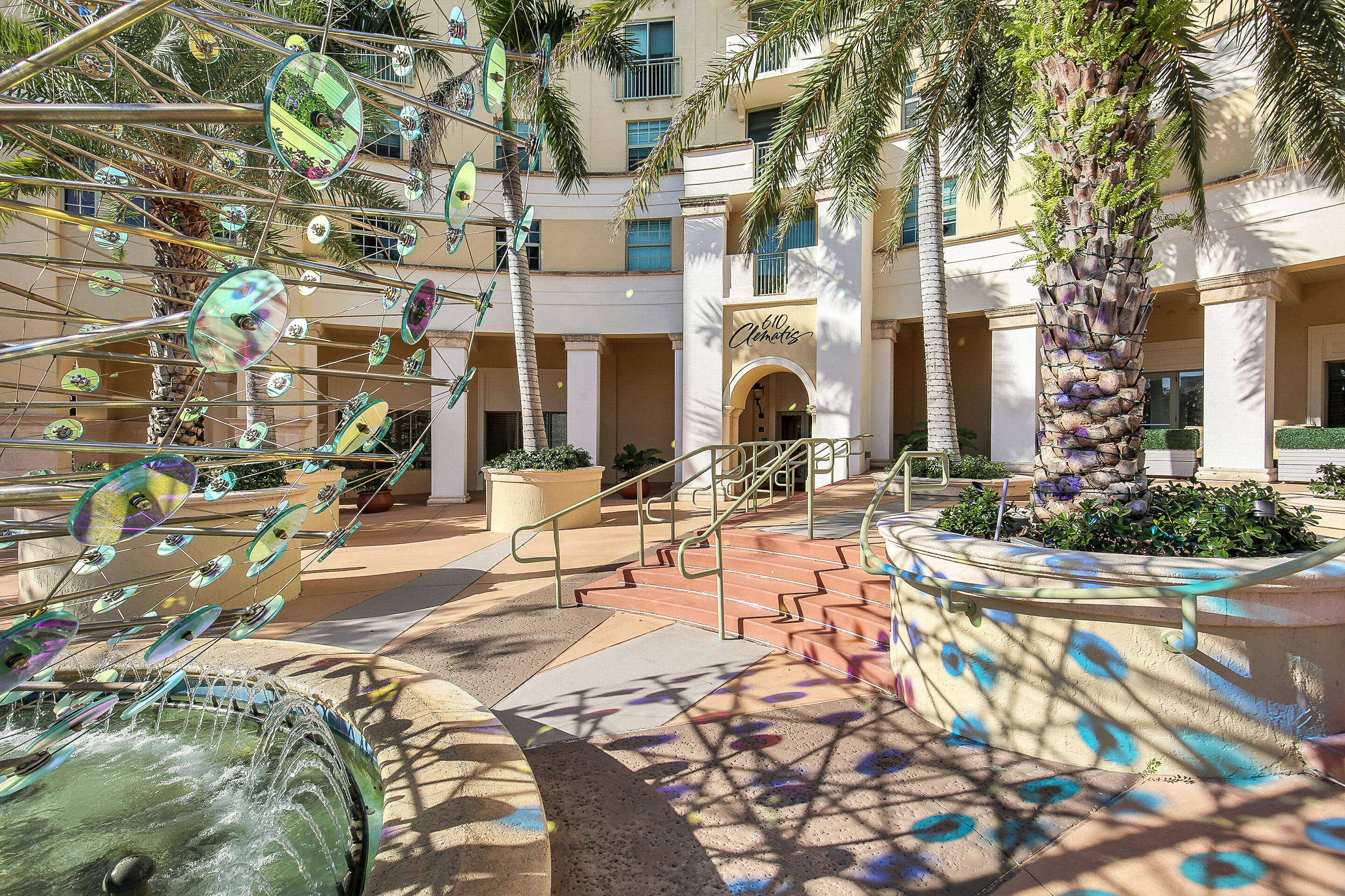610 Clematis Street, Unit 736 West Palm Beach, FL 33401 - Photo 4 of 37 a view of a building with cars park on the roadside