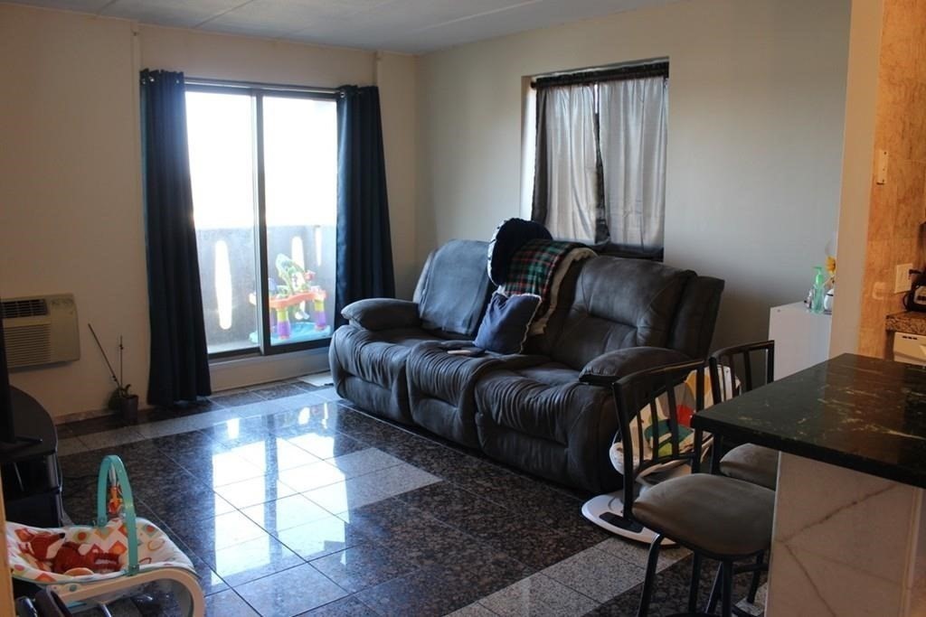 10 Main Street, Unit 507 Framingham, MA 01702 - Photo 5 of 17 a living room with furniture and a window