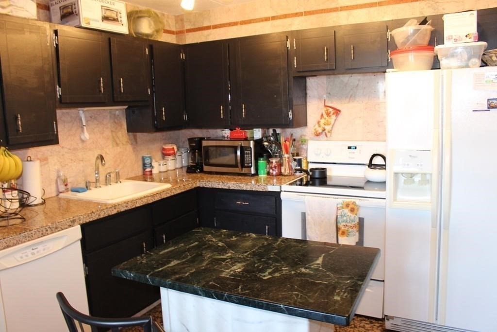 10 Main Street, Unit 507 Framingham, MA 01702 - Photo 7 of 17 a kitchen with a sink and cabinets