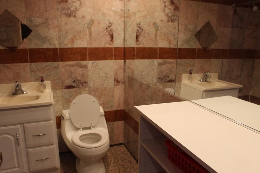 10 Main Street, Unit 507 Framingham, MA 01702 - Photo 8 of 17 a bathroom with a sink and a toilet