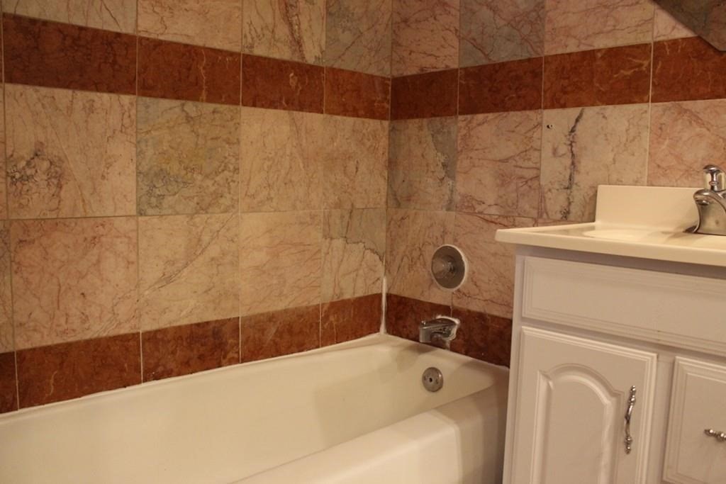 10 Main Street, Unit 507 Framingham, MA 01702 - Photo 9 of 17 a bathroom with a sink and a tub