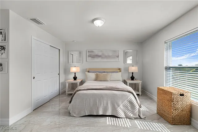 a bedroom with a bed and a couch