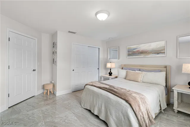 a bedroom with a bed and a painting on the wall