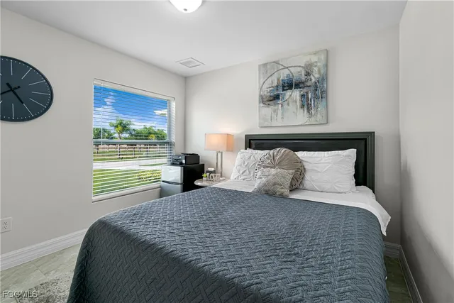 a bedroom with a large bed and a window