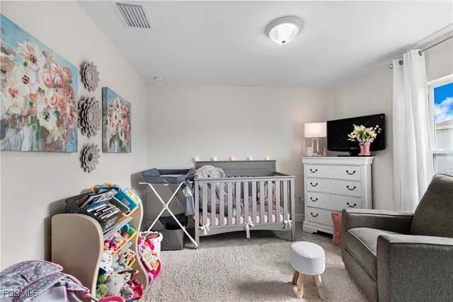 a bedroom with furniture and a flat screen tv