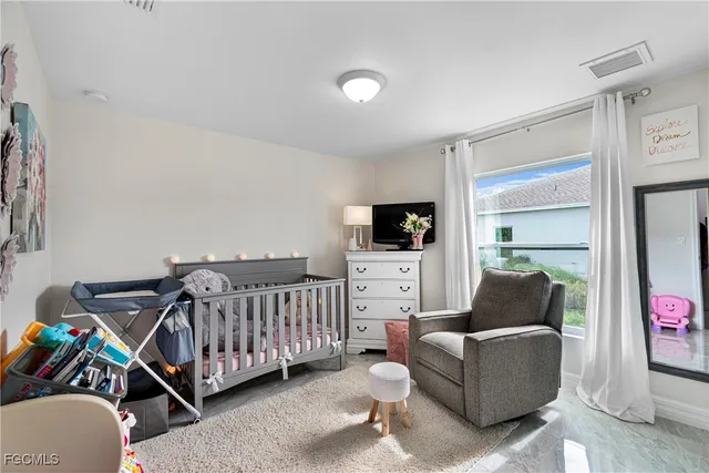 a bedroom with furniture and a flat screen tv