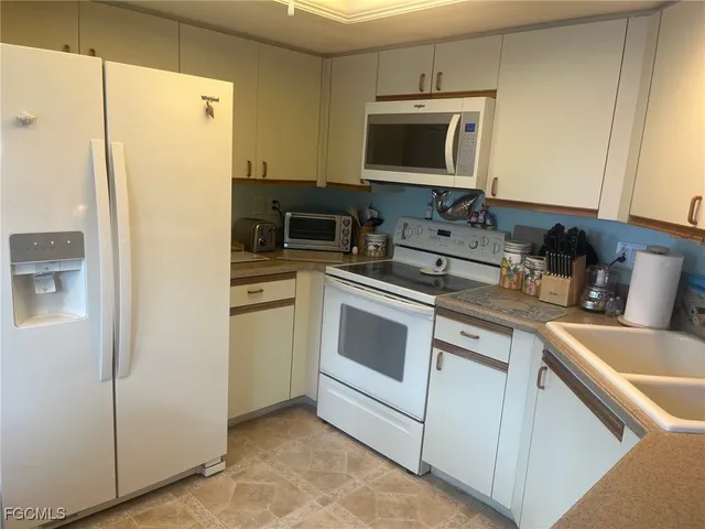a kitchen with stainless steel appliances a stove microwave and refrigerator
