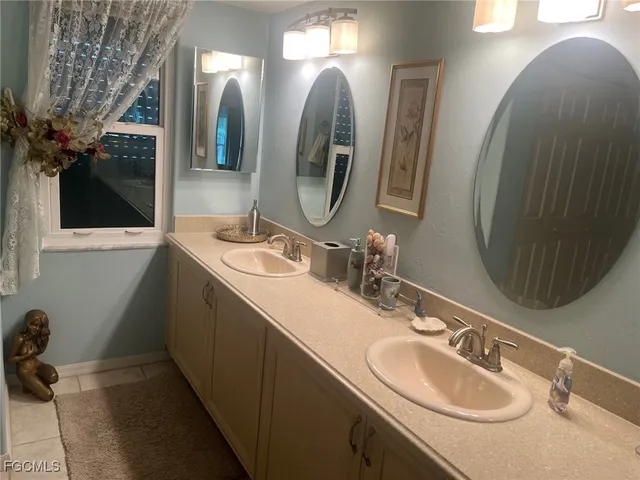 a bathroom with a double vanity sink and a mirror