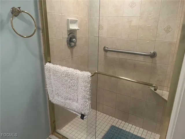 a bathroom with a granite countertop shower and a sink
