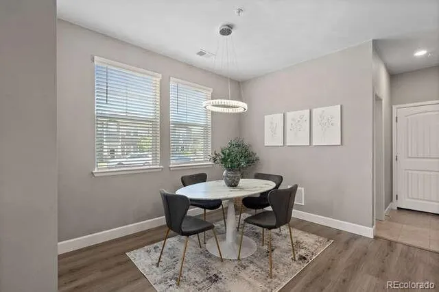 a dining room with furniture and wooden floor