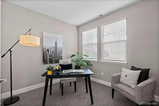 a living room with furniture and a potted plant