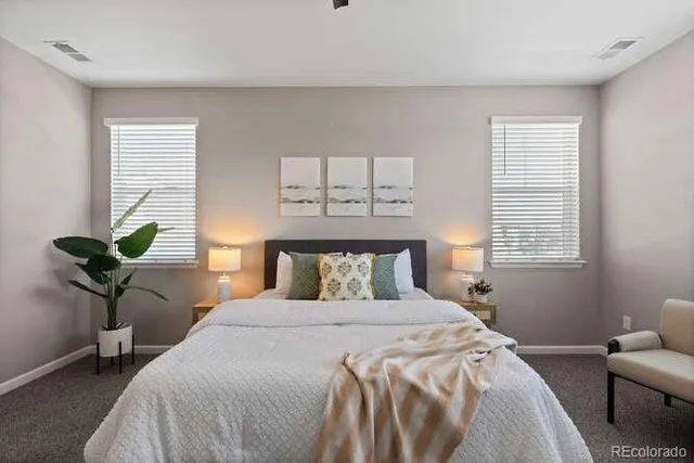 a bedroom with a bed and a potted plant