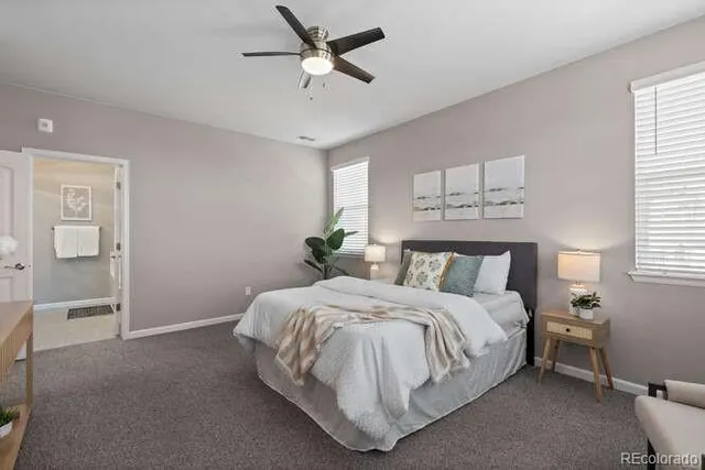a bedroom with a bed chandelier and a window