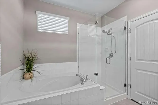 a white bath tub with a shower