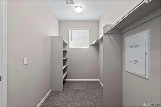 a view of a hallway with wooden shelves