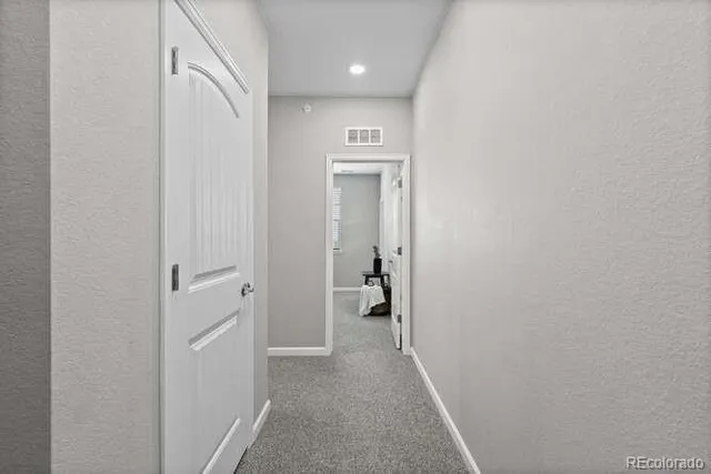 a bedroom with a bed and a potted plant