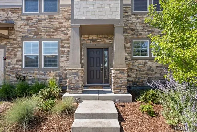 a front view of a house with a garden