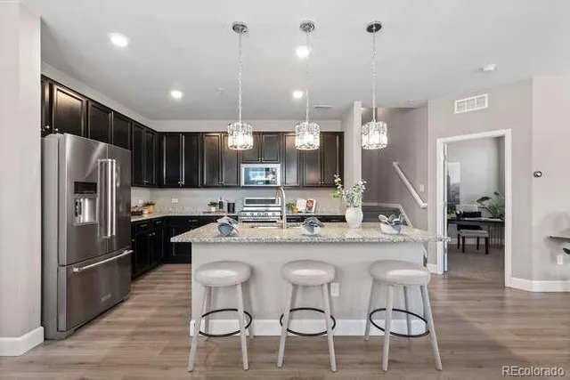 a large kitchen with a table and chairs