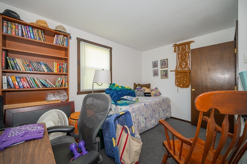 25 Agate Avenue Worcester, MA 01604 - Photo 24 of 34 a living room with furniture a bookshelf and a window