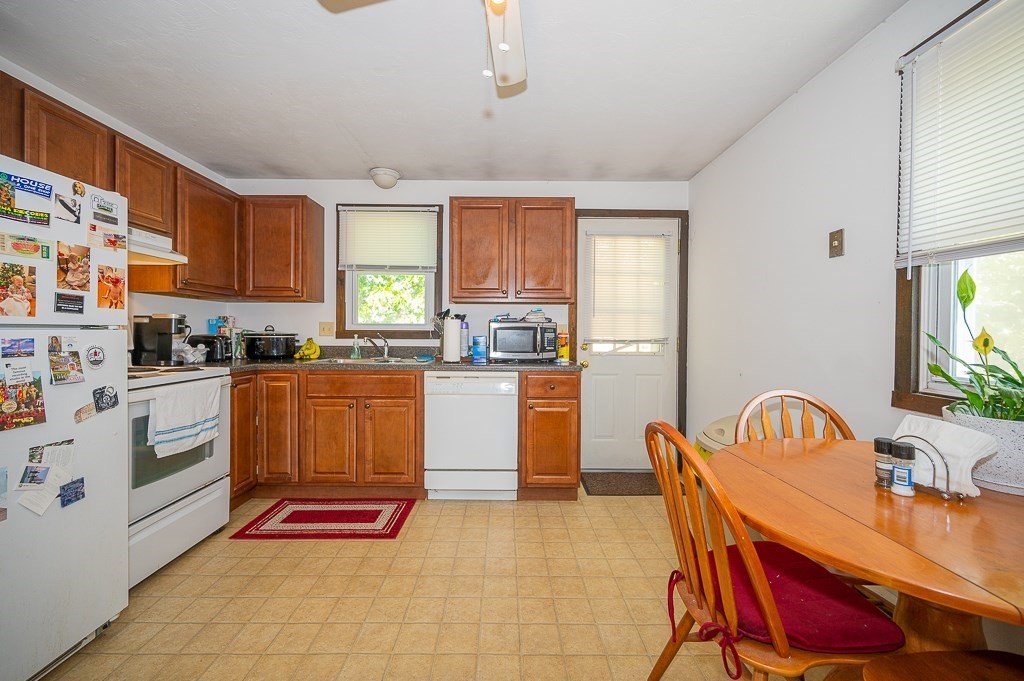 25 Agate Avenue Worcester, MA 01604 - Photo 4 of 34 a kitchen with a dining table chairs and appliances