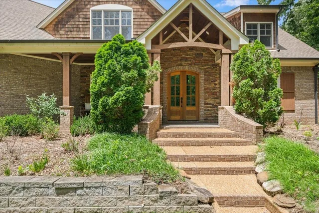 a front view of a house with plants