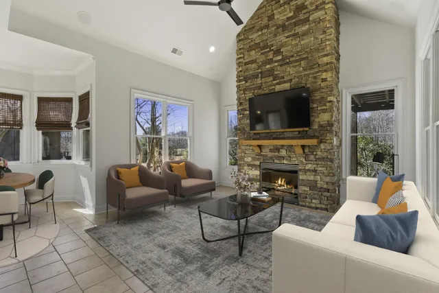 a dining room with furniture a chandelier and window