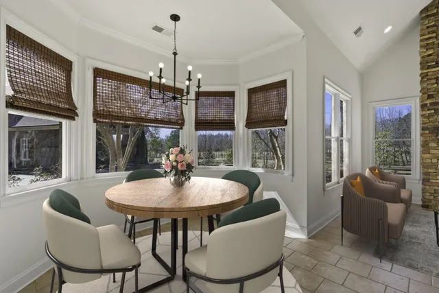a spacious bathroom with a granite countertop sink a mirror and a bathtub
