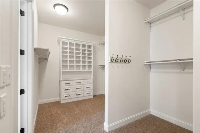 a view of a hallway with white cabinets