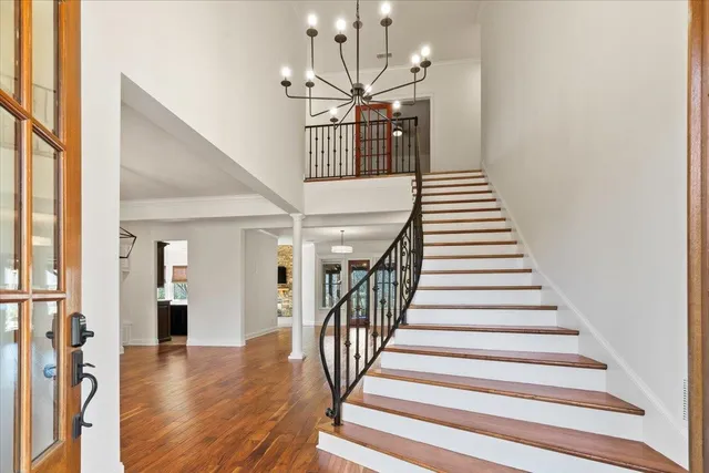 a living room with furniture and a chandelier