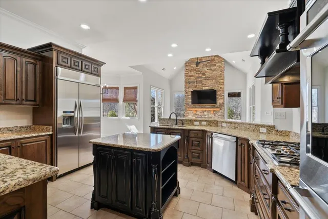 a kitchen with stainless steel appliances granite countertop a sink and a stove
