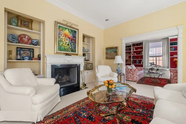 a living room with furniture fireplace and window