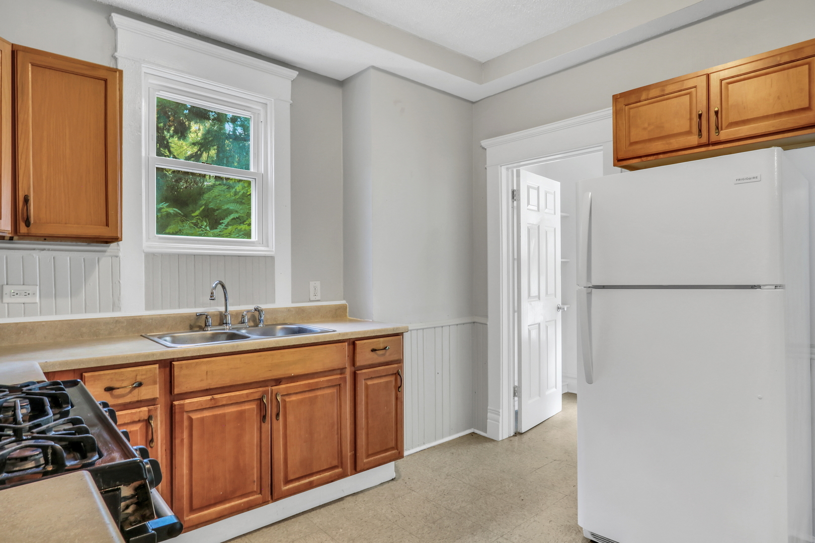 725 18th Street North Chicago, IL 60064 - Photo 14 of 32 a kitchen with stainless steel appliances granite countertop a refrigerator and a sink