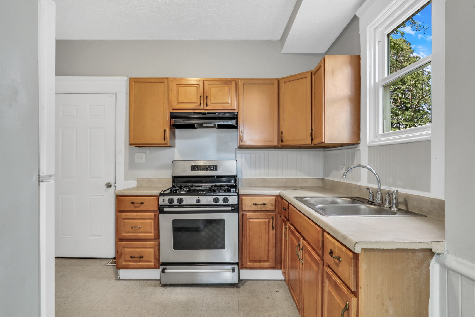 725 18th Street North Chicago, IL 60064 - Photo 15 of 32 a kitchen with a stove and a sink