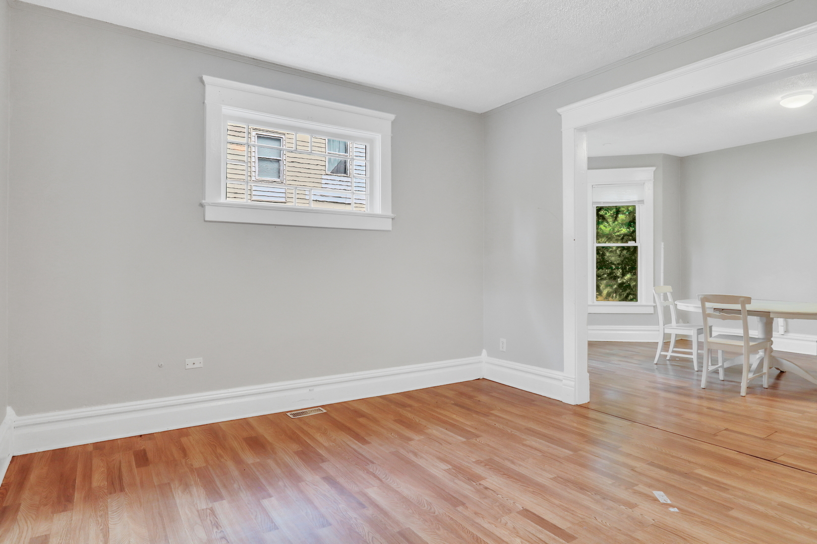 725 18th Street North Chicago, IL 60064 - Photo 8 of 32 a view of empty room with wooden floor and fan