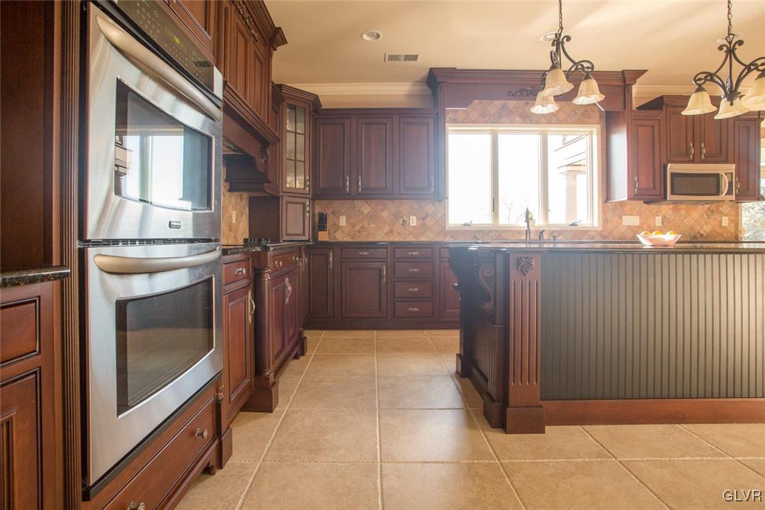 226 East Dell Road Bath, PA 18014 - Photo 11 of 50 a kitchen with stainless steel appliances granite countertop a stove a sink and a microwave