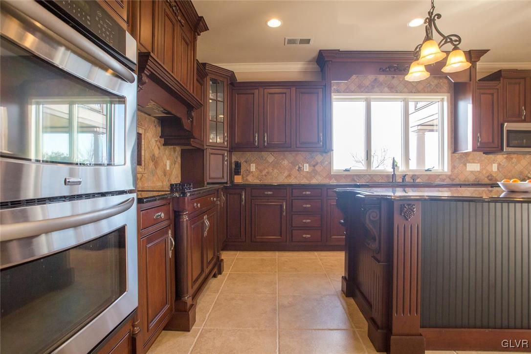 226 East Dell Road Bath, PA 18014 - Photo 9 of 50 a kitchen with stainless steel appliances granite countertop a sink a stove and a refrigerator