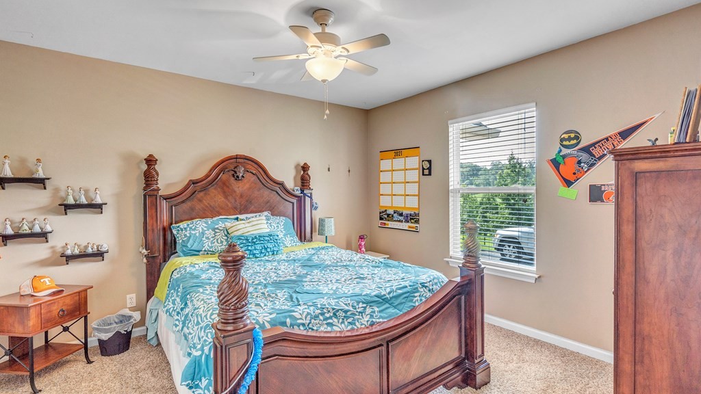 420 No Pone Valley Road Northwest Georgetown, TN 37336 - Photo 28 of 56 a bedroom with a bed and a chandelier