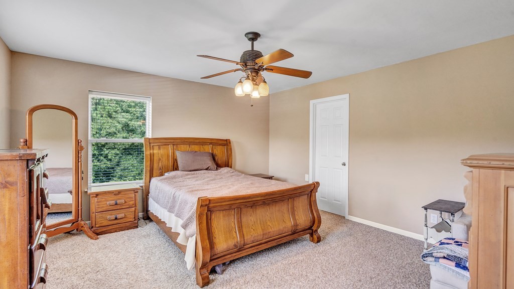 420 No Pone Valley Road Northwest Georgetown, TN 37336 - Photo 31 of 56 a bedroom with a bed and a chandelier