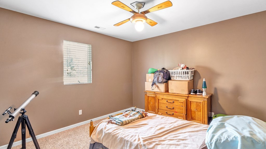 420 No Pone Valley Road Northwest Georgetown, TN 37336 - Photo 38 of 56 a bedroom with a bed and a chandelier