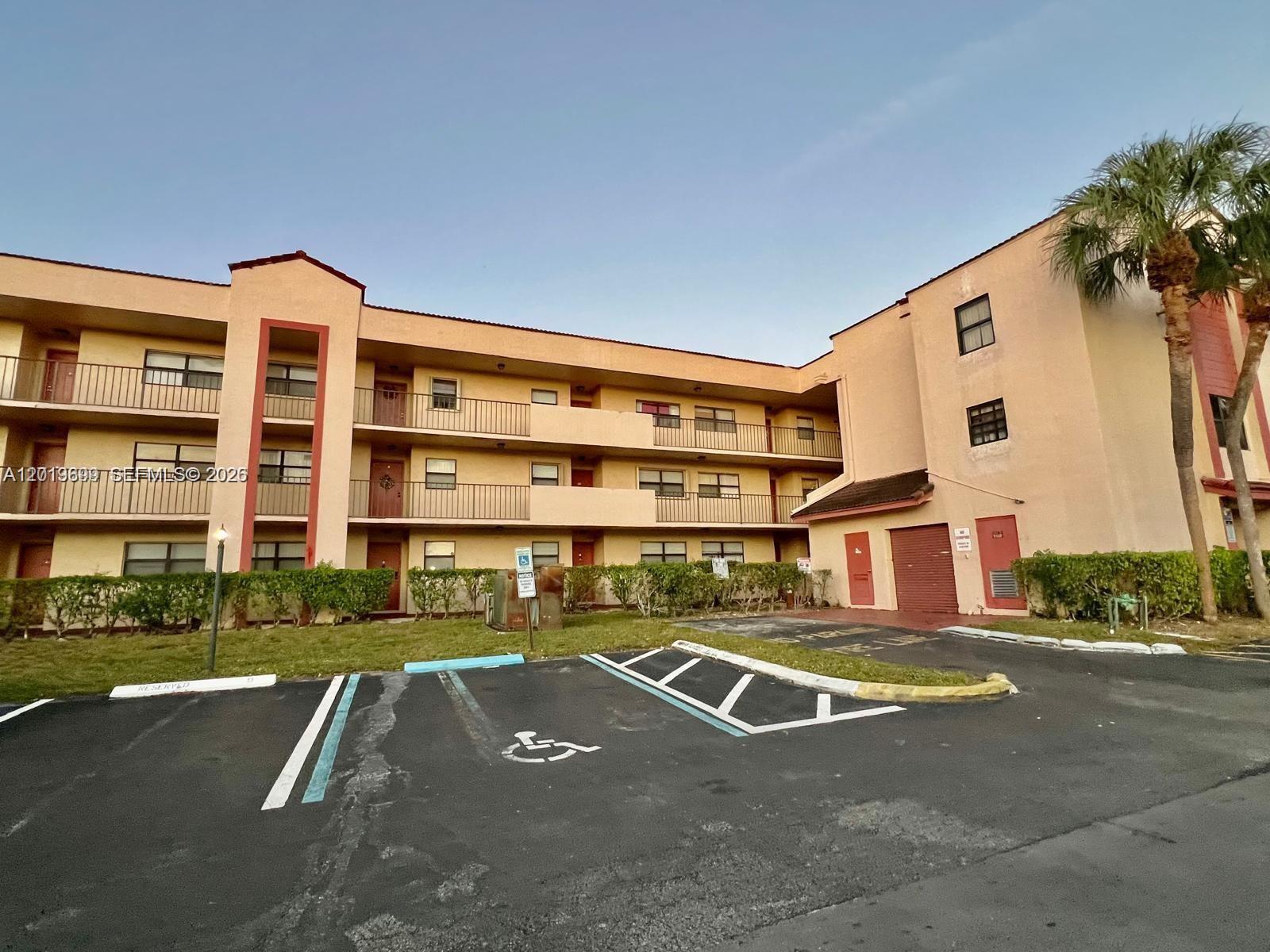 3470 Foxcroft Road, Unit 204 Miramar, FL 33025 - Photo 2 of 40 a view of an apartment with swimming pool and chairs