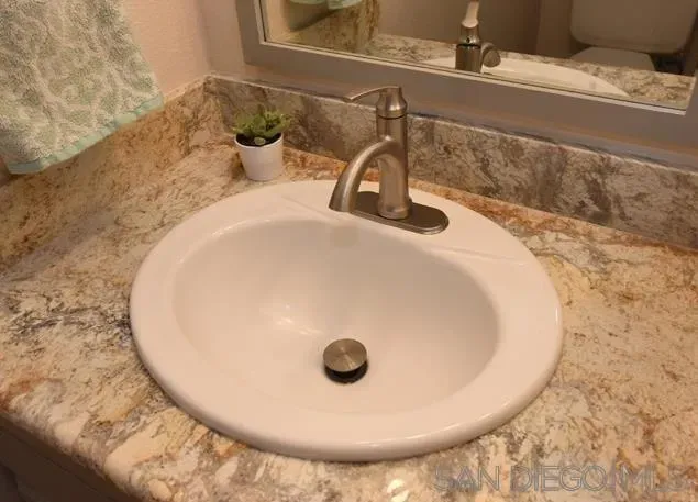 a bathroom with a sink and mirror