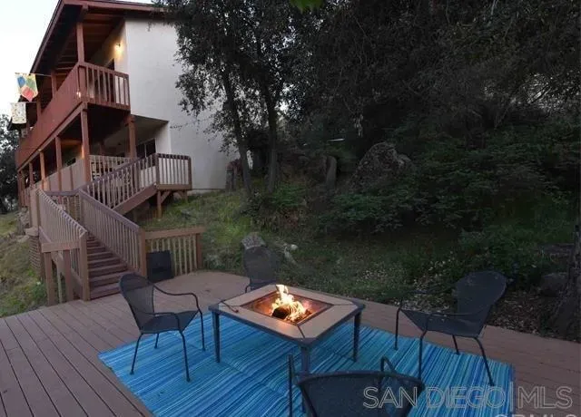 a view of balcony with wooden floor and outdoor seating